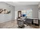 Bright home office with natural light, tile floors, and practical workspace arrangement at 15453 W Shangri La Rd, Surprise, AZ 85379