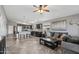 Open-concept living room featuring a kitchen with dark cabinetry, tile flooring, and a comfortable sofa at 15453 W Shangri La Rd, Surprise, AZ 85379