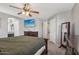 Comfortable primary bedroom featuring neutral colored walls, soft carpet, large wooden furniture and an entertainment center at 15453 W Shangri La Rd, Surprise, AZ 85379
