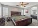 Spacious primary bedroom with neutral paint, carpeted flooring, a large wooden bed frame and access to ensuite at 15453 W Shangri La Rd, Surprise, AZ 85379