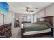 Primary bedroom features neutral colored walls, soft carpet, a large wooden bed and TV at 15453 W Shangri La Rd, Surprise, AZ 85379