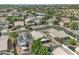 A high angle view of a residential neighborhood with neatly arranged homes and tree-lined streets at 15470 W Mauna Loa Ln, Surprise, AZ 85379