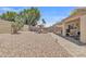 Spacious backyard with desert landscaping, brick pavers, and a covered patio area at 15470 W Mauna Loa Ln, Surprise, AZ 85379