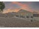 Expansive backyard featuring desert landscaping, a covered patio, and outdoor entertaining space at 15470 W Mauna Loa Ln, Surprise, AZ 85379
