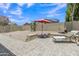 Large private backyard complete with lounge seating and desert landscaping for easy maintenance, backing to green space at 15470 W Mauna Loa Ln, Surprise, AZ 85379