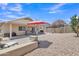Expansive backyard featuring a covered patio, outdoor seating, and desert-friendly landscaping for easy maintenance at 15470 W Mauna Loa Ln, Surprise, AZ 85379