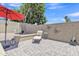 Private patio area features stylish pavers, a chaise lounge, and a decorative wall, perfect for outdoor relaxation at 15470 W Mauna Loa Ln, Surprise, AZ 85379