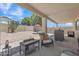 Inviting backyard with covered patio, seating area, and low-maintenance desert landscaping at 15470 W Mauna Loa Ln, Surprise, AZ 85379