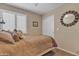 Serene bedroom with plush bedding, stylish accents, and a closet with sliding doors for convenience and space saving at 15470 W Mauna Loa Ln, Surprise, AZ 85379