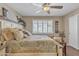 Bedroom with ceiling fan, light colored wall, and plantation shutters offering serene natural light at 15470 W Mauna Loa Ln, Surprise, AZ 85379