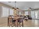 Cozy dining area with wooden table, neutral walls, plantation shutters for natural light, and an open layout at 15470 W Mauna Loa Ln, Surprise, AZ 85379