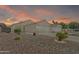 Charming single-story home with a well-manicured, low-maintenance rock front yard and a two-car garage at 15470 W Mauna Loa Ln, Surprise, AZ 85379