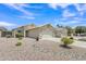Charming single-story home with a well-manicured, low-maintenance rock front yard and a two-car garage at 15470 W Mauna Loa Ln, Surprise, AZ 85379