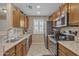 A practical kitchen with stainless steel appliances, ample cabinet storage, and neutral countertops at 15470 W Mauna Loa Ln, Surprise, AZ 85379