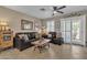 Cozy living room featuring comfortable seating, tile flooring, and natural light through window at 15470 W Mauna Loa Ln, Surprise, AZ 85379
