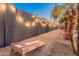 Charming backyard with string lights, a cornhole game, and desert landscaping at 16375 W Cortez St, Surprise, AZ 85388