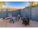 Cozy backyard patio features comfortable seating, a fire pit, and a charming ambiance for relaxing evenings at 16375 W Cortez St, Surprise, AZ 85388