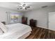 Comfortable bedroom with a ceiling fan, hardwood floors, and a well-lit window for a bright space at 16375 W Cortez St, Surprise, AZ 85388
