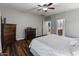 Bedroom showcasing neutral walls, hardwood floors, and an adjacent bathroom at 16375 W Cortez St, Surprise, AZ 85388