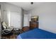 This bedroom features a bed, sleek dresser, gaming chair and good closet space at 16375 W Cortez St, Surprise, AZ 85388
