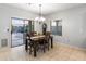 Dining area with access to the backyard, tile flooring, and a classic grandfather clock at 16375 W Cortez St, Surprise, AZ 85388