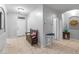 Inviting entryway featuring tile flooring and a charming wooden bench with a comfortable pink pillow accent at 16375 W Cortez St, Surprise, AZ 85388