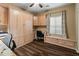 This home office features custom cabinets, granite desktop and a comfortable window seat with built-in storage at 16375 W Cortez St, Surprise, AZ 85388