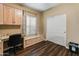 This home office features custom cabinets, granite desktop and a comfortable window seat with built-in storage at 16375 W Cortez St, Surprise, AZ 85388