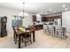 This open kitchen features a long island, a dining table and stainless steel appliances at 16375 W Cortez St, Surprise, AZ 85388