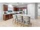 Modern kitchen with granite countertops, stainless steel appliances, and a center island with barstool seating at 16375 W Cortez St, Surprise, AZ 85388