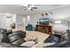 Comfortable living room features a large sectional couch, decorative state art, and tile flooring at 16375 W Cortez St, Surprise, AZ 85388