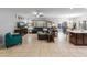 Open concept living room showing spacious tile flooring and easy access to dining area and backyard at 16375 W Cortez St, Surprise, AZ 85388