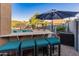 Outdoor bar area with comfortable seating, perfect for enjoying drinks by the pool in a resort-style backyard at 16375 W Cortez St, Surprise, AZ 85388