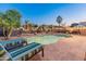 Inviting backyard with a refreshing pool, lounge chairs, and lush greenery, perfect for relaxation at 16375 W Cortez St, Surprise, AZ 85388