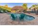 Backyard pool with lounge chairs and lush landscaping, perfect for relaxation and entertainment at 16375 W Cortez St, Surprise, AZ 85388