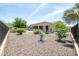 Landscaped backyard with desert rock and lush greenery at 16772 W Cypress St, Goodyear, AZ 85395