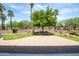 Lush backyard features a paver patio, artificial turf, and mature landscaping, creating a private outdoor oasis at 16772 W Cypress St, Goodyear, AZ 85395