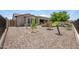Backyard with desert landscaping, including desert plants and trees around the fence line at 16772 W Cypress St, Goodyear, AZ 85395
