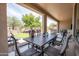 Relaxing covered patio with dining table and chairs, providing a perfect spot to enjoy the backyard view at 16772 W Cypress St, Goodyear, AZ 85395