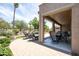 Backyard retreat featuring a covered patio, lounge chairs, and beautifully landscaped yard, perfect for outdoor living at 16772 W Cypress St, Goodyear, AZ 85395