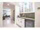 Stylish bar area featuring modern white cabinets, countertop space, and a beverage refrigerator at 16772 W Cypress St, Goodyear, AZ 85395