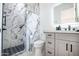 Modern bathroom featuring a sleek vanity, illuminated mirror, and a stylish shower with marble tile at 16772 W Cypress St, Goodyear, AZ 85395