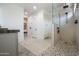 Modern primary bath featuring stone floors, a walk-in shower, and plenty of storage at 16772 W Cypress St, Goodyear, AZ 85395