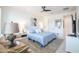 Comfortable bedroom with a bed, side tables, and lounge chair near the window at 16772 W Cypress St, Goodyear, AZ 85395