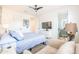 Spacious bedroom with soft chair, large window, and television at 16772 W Cypress St, Goodyear, AZ 85395
