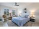 Bright bedroom with a large bed, ceiling fan, and two side tables at 16772 W Cypress St, Goodyear, AZ 85395