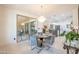 Open dining area featuring a modern chandelier with kitchen views and access to an outdoor living space at 16772 W Cypress St, Goodyear, AZ 85395