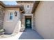 Inviting front entrance with stone accents, manicured plants, and a stylish, modern door at 16772 W Cypress St, Goodyear, AZ 85395