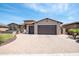 A well-kept home featuring a paved circular driveway and a spacious two-car garage at 16772 W Cypress St, Goodyear, AZ 85395