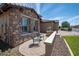 A comfortable seating area on the front patio with stone detailing and manicured landscaping at 16772 W Cypress St, Goodyear, AZ 85395